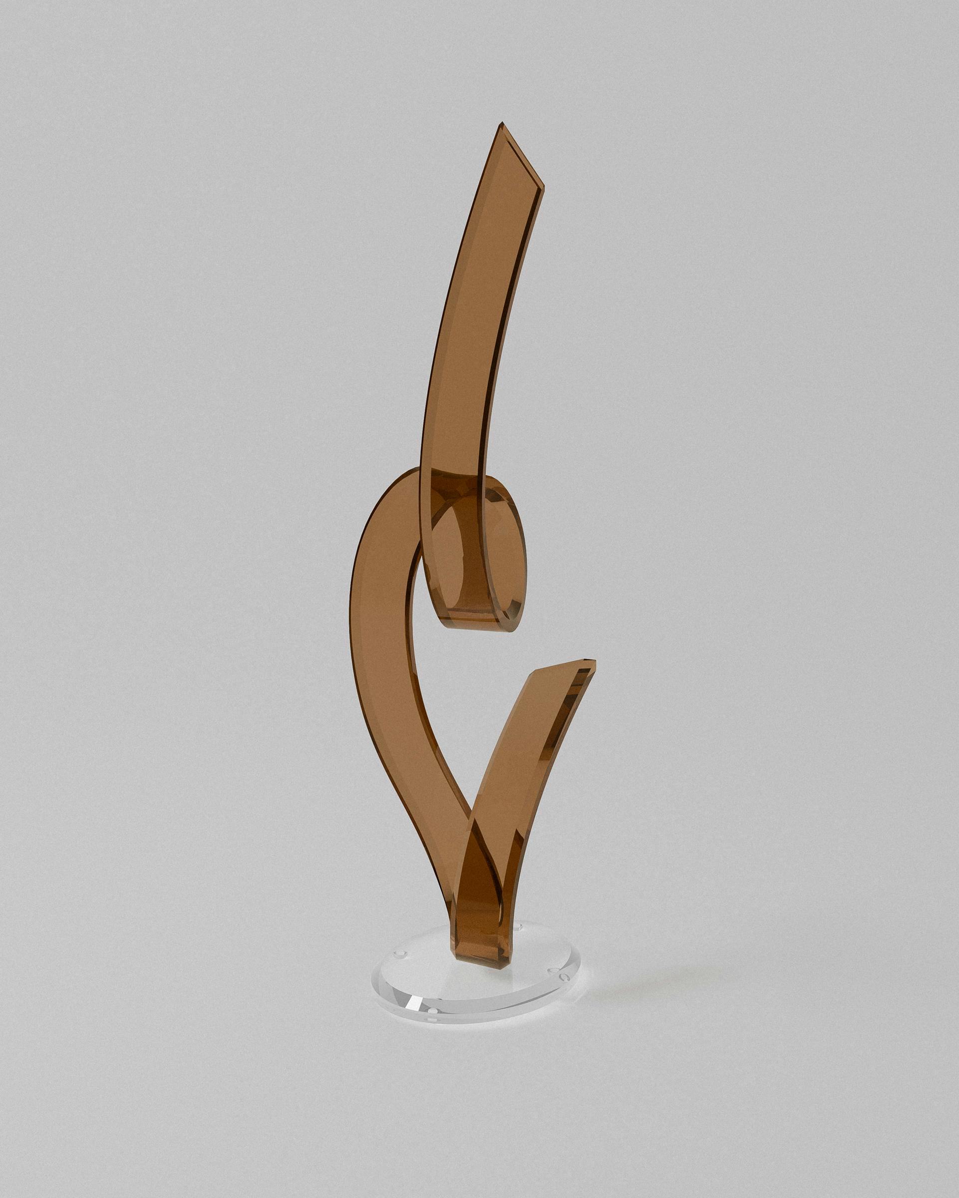 Harmony acrylic sculptural object – Amber acrylic ribbon sculpture on clear base. | MUÑIZ Miami